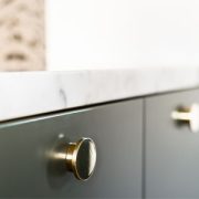 custom kitchen cabinets with gold handles.